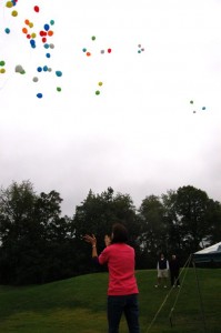 Daughter, Steele Ott, Claps As The Balloons In Her Mother's Memory Float Away