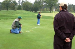 Volunterrs Measure The Distance On A Try For The Million Dollar Hole In One