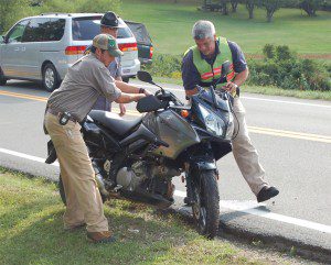Crews move wrecked motorcycle from roadway. -- Photo by Yvette Stafford