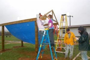 Volunteers from APO work on that will be a covered picnic area at RVCC.