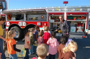 Stuart Smith of Wintergreen Fire Department shows students some of the gear on used their ladder truck.
