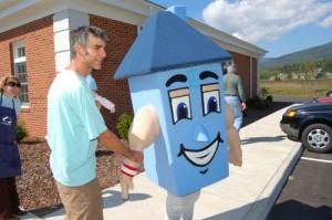 Bill Hess of Afton, shakes the hand of Homer the mascot at Community Day in Nellysford, Virginia