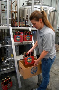 Photo By Tommy Stafford : Mandi Smack, co-owner of Blue Mountain Brewery in Afton, Virginia packs up a six pack of Lights Out holiday beer.