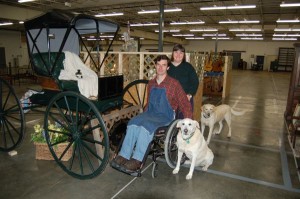 Larry Whitaker, Judy Barnes and Boo, (front dog) in an NCL picture from the Blue Moon Antique Mall opening in 2006.
