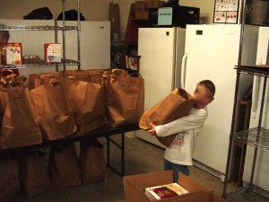A youngster gets one of the many holiday meal sack provided by the Nelson Food Pantry.