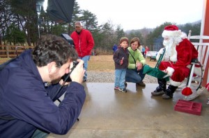 Photo By Tommy Stafford : ©2008 NCL : Pro photographer, Ben Hernandez, snaps a child visiting Santa at MountainSide Petting Farm in Afton, Virginia
