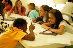 ©2009 NCL Magazine : Members of Junior/Cadette Troop 249 talk over methods used to layout magazines and newspapers.