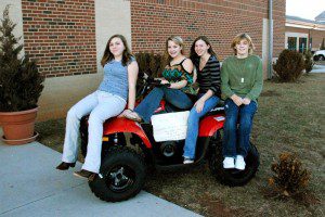 Students show off a Polaris Trail Boss 4 wheeler that is being raffled off between now and April 3rd to help raise even more money.