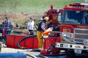 Crews from Crozet and Wintergreen work to dump water into a temporary basin to fight the fire. 