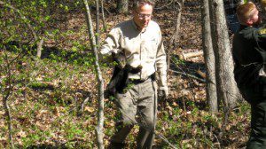 Representatives including two bear biologists from The Virginia Department of Game and Inland Fisheries take one of the cubs to safety.