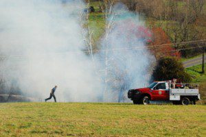 Photos By Ann Strober : ©2009 NCL Magazine : A fireman runs back toward his truck during Thursday afternoon's brush fire in the vicinity of Tuckahoe Antique Mall north of Nellysford, Virginia