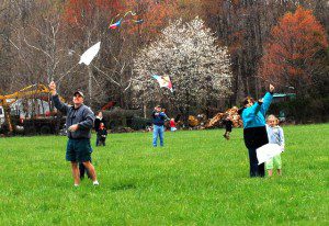 By Ann Strober : Several parents and youngsters launch their kites over Spruce Creek Saturday afternoon.