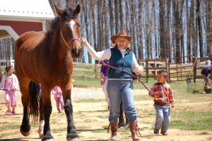 Barbara Funke brings out one of the horse at MountainSide Petting Farm this past Sunday.
