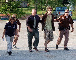 © 2009 Nelson County life Magazine. Photo by Tommy Stafford. 20 year-old Austin Griffin is led to a bond hearing by Sheriff David Brooks.(right) Inv. Becky Adcock, Capt. Ron Roberson, and Inv. Paul McCormick accompany Griffin. 