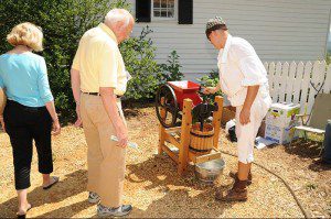 An old apple press is demonstrated.