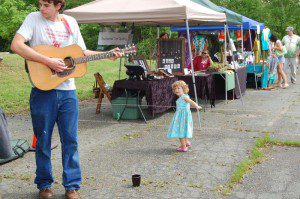 A youngster dances to the live music at The Schuyler Community Farmers' Market.