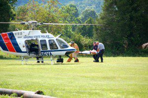 Crews from Wintergreen & Rockfish Fire and Rescue prepare to load one of the patients into a VA State Police Helicopter Sunday afternoon at RVCC.
