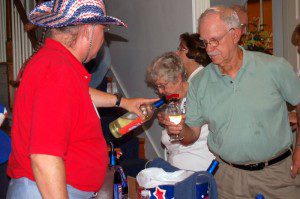 Photos By Yvette Stafford : ©2009 www.nelsoncountylife.com : Democracy Vineyards co-founder, Jim Turpin, pours up one of his white wines at Friday night's debut inside The Lovingston Opry.