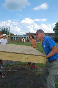 The young men help Gifford Childs of RVCC move a platform into place.