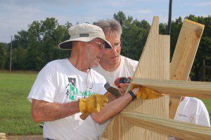 Bill Howard (left) and Michael Donegan help to assemble bracing beams for the half pipe.