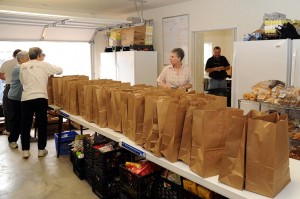 Volunteers at The Nelson County Pantry break out food into individual sacks for distribution. 