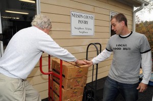 Dick Nees (left) with The Nelson Pantry, helps offload food delivered Friday morning. 