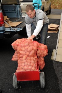Photos By Paul Purpura : ©2009 www.nelsoncountylife.com : A rep from The Local Food Hub in Charlottesville wheels in a portion of over 400 pounds of potatoes Friday at The Nelson County Pantry.