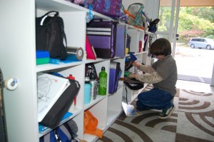 Lawson Johnson, a middle schooler at NBS, grabs his books from the new shelving in North Branch's new annex.