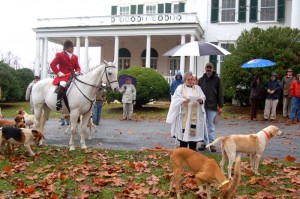 Rev. Judy Parrish of Trinity Episcopal Church in Massies Mill performs the annual blessing of the hounds, horses and riders before the hunt starts. 