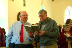 Rev. Tom Fowler and Earl sing from a hymnal at Saturday morning's special service in Schuyler.
