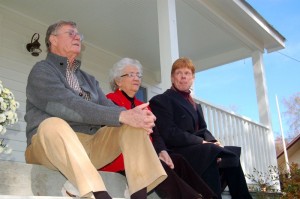 Hamner, Grinnell, and Walmsley sit on the front porch of the house in Schuyler where Earl grew up as a young man. The house was just renovated and opened for a tour Saturday.