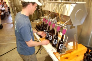Matt lines up the dark hollow bottles for filling at the brewery. 