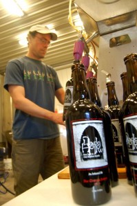©2010 www.nelsoncountylife.com : Photo By Tommy Stafford : Matt Nucci, co-owner of BMB, bottles one of many Dark Hollow Ale's Wednesday afternoon in Afton. 