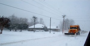 A VDOT snow plow pushes snow off of Route 151 in Nellysford, Virginia.