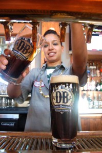Siporah Winsheimer taps one of Jason's fresly brewed beers at DBBC. 