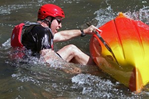 John Fritschi, of Hampton  exits his kayak after flipping at the start of the paddling portion of the Piney River Mini Triathlon held Saturday April 10, 2010.  He quickly dumped the water out of the boat and continued.