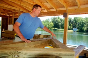 Photo By Tommy Stafford : ©2010 www.nelsoncountylife.com : Chris Shepard, Lake Manager, at Lake Monocan in Stoney Creek, works on the framing for a life jacket roof. The lake starts opening Memorial Day Weekend. 