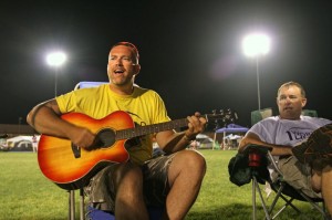 John Wright plays the guitar and sings with his friend Lynwood Bridge as they pass some time during the Relay for Life, held Saturday May 15, 2010 at Nelson County High School.
