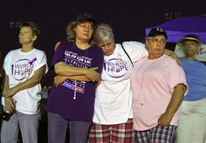 Sue Harlow, second from left, Annette Campbell and Rita Mayo remember family members who have passed away during the luminary ceremony at the Relay for Life event, held Saturday May 15, 2010 at Nelson County High School.