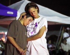 Ramona Wright, at right, consoles Johnny Gillespie as he remembers his grandmother during the luminary ceremony at the Relay for Life event held at Nelson County High School, Saturday May 15, 2010.