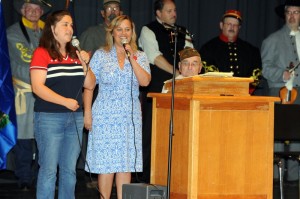 Tonya Bodek (left) and her mother sing the Armed Forces Medley at Sunday's program in Lovingston.