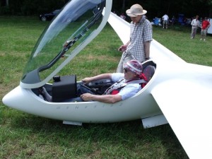 Hal Loken sits in his glider waiting on a tow while chatting it up with a friend. 