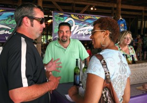 Photo By Norm Shafer : ©2010 www.nelsoncountylife.com : Jeff Stone, winemaker at Wintergreen Winery, at left,  talks to Sonia R. Banks of Richmond about their wine offerings while Adam Diaz looks on at the Summer Solstice Festival, Saturday June 19, 2010 at Lazy Days Winery / Amherst Estate Vineyards in Amherst, Va.