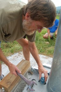 J.K. Kennedy with Tectonics Builders tightens bolts at the base of the wind turbine located just behind Devils Backbone at the intersection of Route 151 and 664.