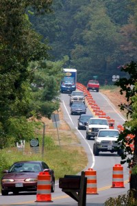 ©2010 www.nelsoncountylife.com : Cars narrow to one lane on 151 in Greenfield passing a sign (lower left) marking the spot where 48 year old Laura Cavedo and her two daughters were killed in August of 2007. 
