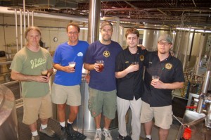 Jacque Landry, (partner & brewer South Street Brewery) Matt Nucci, (brewer and co-owner Blue Mountain Brewery) Mark Thompson, (owner and brewmaster Starr Hill) Aaron Reilly, (brewer Devils Backbone) and Jason Oliver, (head brewmaster Devils Backbone) stand by one of the two tanks of a collaborative brew being made for release at this year's Brew Ridge Trail Music Festival in August.  