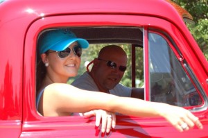 Tim Spicer, Operations Manager of Tiger Fuel in Lovingston, peeks around wife Amanda in this vintage pickup during the parade. 