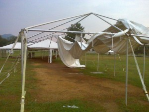Photo By Tommy Stafford : ©2010 www.nelsoncountylife.com : The final day of summer was not kind to the farmers market tent in Nellysford. A strong thunderstorm ripped up the notthern portion of the tent near the entrance to Stoney Creek. Click to enlarge. 