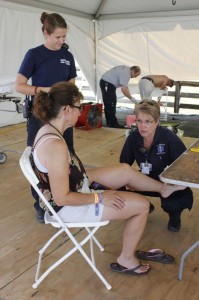 Betsy Smith with WF&R (kneeling right) tends to a minor injury at the 2013 Lockn' Festival. 