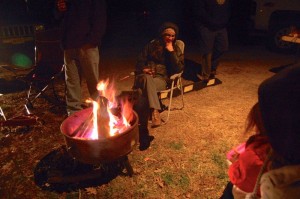 People waiting their turn to bounce huddle around a toasty fire Tuesday night at Bouncing For Turkeys held at Devils Backbone Brewing. 